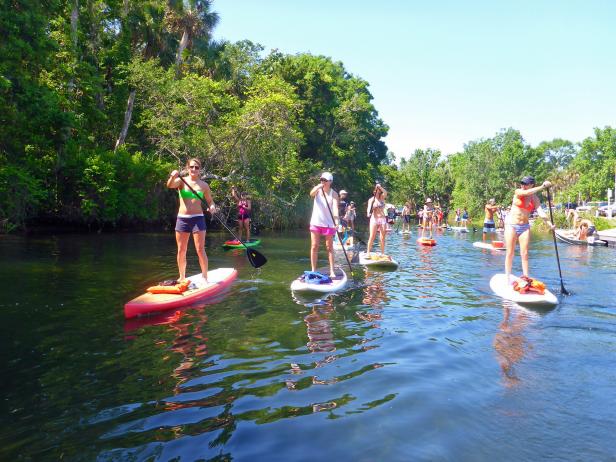 A group stand-up paddleboarding A group stand-up paddleboarding