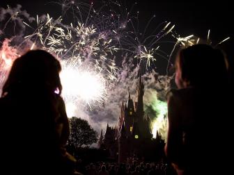 Two children watch the fireworks display as it explodes over Cinderella's Castle at Disney World's Magic Kingdom in Orlando, Florida, May 7, 2008. The complex is reportedly the most visited and largest recreational resort in the world, containing four theme parks, two water parks, twenty-three themed hotels, and numerous shopping, dining, entertainment and recreation venues. Disney World opened on October 1, 1971.
