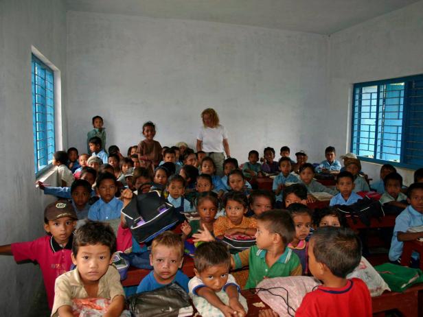 Young children fill a school room in Nepal.
