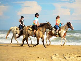 Horseback riding along the surf at the beach on Hatteras Island with Equine Adventures.