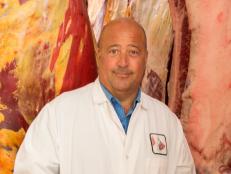 Andrew Zimmern in front of meat in Wisconsin