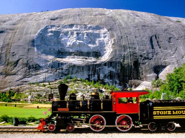 train, mountain, carving in mountain cliff, blue sky, greenery, daylight,