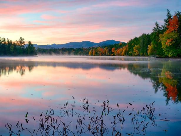 dawn, lake, trees with colored leaves, mountains in distance dawn, lake, trees with colored leaves, mountains in distance