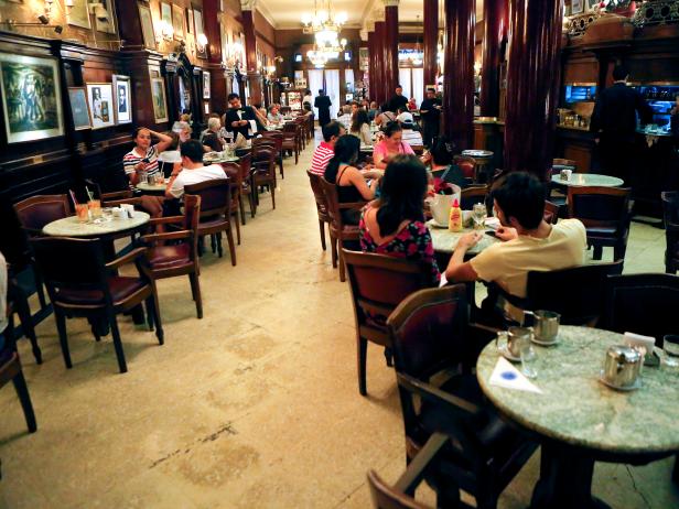 people sit indoors at a classy cafe in buenos aires people sit indoors at a classy cafe in buenos aires