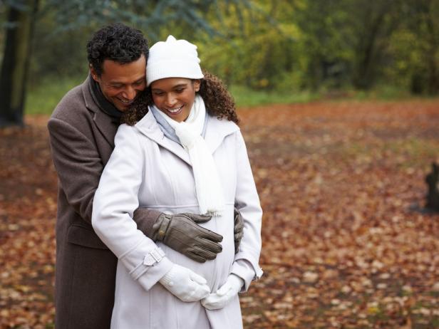 Pregnant woman and husband bundled up for fall Pregnant woman and husband bundled up for fall
