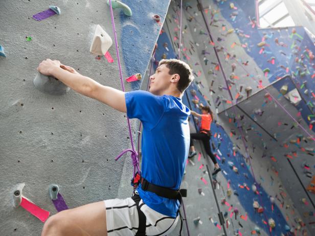 Man climbs indoor climbing wall