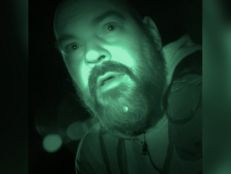 An infrared photo of a bearded man with a shocked look on his face.