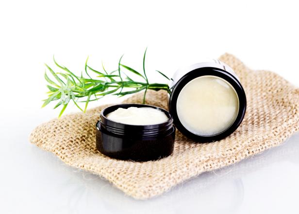 Natural lip balm and skin salve made with organic oils and butters in black tin