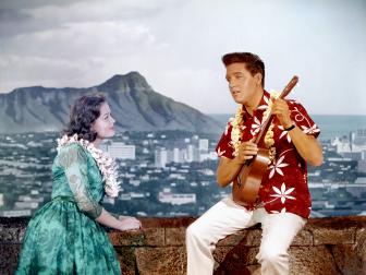 LOS ANGELES - APRIL 1964: Rock and roll singer and actor Elvis Presley in a movie still with a woman on the set of 'Blue Hawaii' at Paramount Pictures in April of 1961 in Los Angeles, California. (Photo by Michael Ochs Archives/Getty Images)