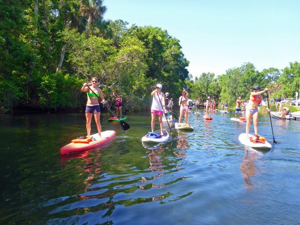 A group stand-up paddleboarding