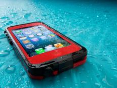 San Diego, California, United States - July 29th, 2013: This is the Apple iphone 5 in a red lifeproof case. It was photographed in the studio at a low angle and spritzed with water. Apple Inc. is the leading manufacturer in smart phones. It recently released the new IOS 7 operating system. Lifeproof caes enable the iPhone to be submersed up to 6 1/2 feet of water and protect it from falls and dirt as well.