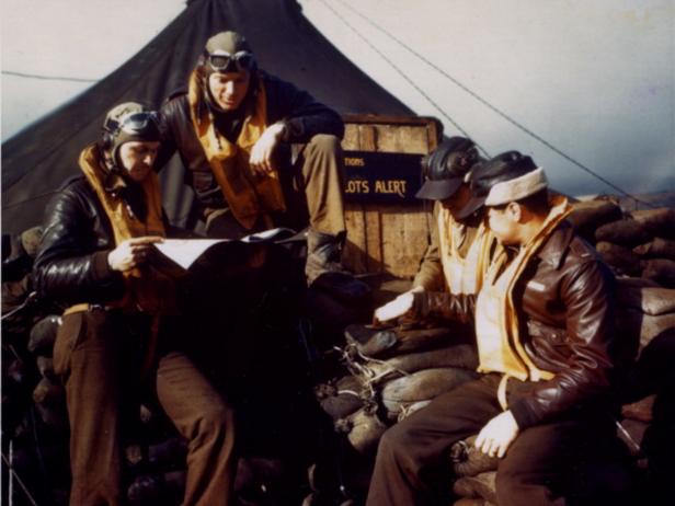 Four United States Army pilots discussing their mission just before the take off, Aleutian Islands, ca 1945. (Photo by PhotoQuest/Getty Images)