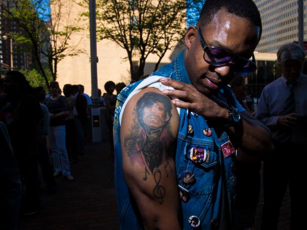 BALTIMORE, MD - MAY 10: Luther Washington shows off his Prince tattoo as he waits to see Prince for the 8th time as people line up to see singer Prince as he performs at the Baltimore's Royal Farms Arena on Mother's Day as part of his Rally 4 Peace event in Baltimore, MD on Sunday May 10, 2015. (Photo by Jabin Botsford/The Washington Post via Getty Images)
