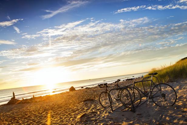 Bicycles parked on beach at sunset
