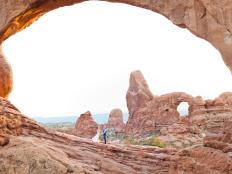 The stunning rock formations create a natural canopy or â  chuppahâ   for couples marrying in Arches. Though the park allows the assembled to celebrate with a cookout afterward, many couples head to a hotel or resort in Moab for their receptions. Photo couresy of Moab photographer Angela Hayes.