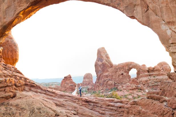 The stunning rock formations create a natural canopy or â  chuppahâ   for couples marrying in Arches. Though the park allows the assembled to celebrate with a cookout afterward, many couples head to a hotel or resort in Moab for their receptions. Photo couresy of Moab photographer Angela Hayes.