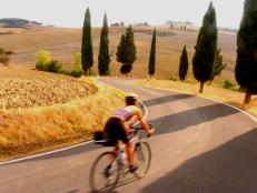 Woman road cycling in Tuscany, Italy