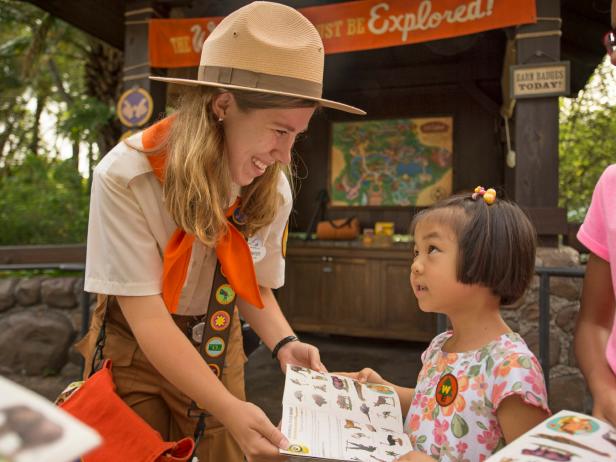 Cast member giving Wilderness book to child