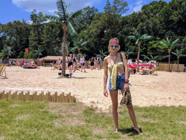 Summery festivalgoer Marley White, from South Carolina, enjoys Bonnaroo Beach before the music begins.
