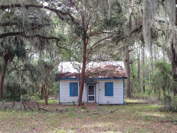 This is a typical example of a Gullah house that is painted Haint Blue on the windows in order to repel evil spirits.