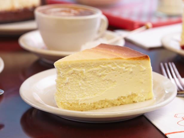 A slice of Junior's cheesecake on a plate.