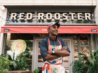 Chef Marcus Samuelsson standing in front of Red Rooster Harlem in NYC>