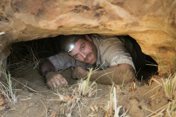 Josh Gates inside a small cavity in the rocks at Gebel el-Silsila in Upper Egypt, as seen on Travel Channel's Expedition Unknown.