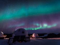 Night Shot of Dome Huts With Vivid Northern Lights Above in the Sky