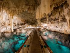A lot of underground caves have pretty pools, but, at Crystal Cave, you can walk on water. Literally. Floating pontoon rafts create bridges that span across the crystal clear waters. The water is so clear that cave formations look incredibly close but are nearly 50 feet below the water’s surface.