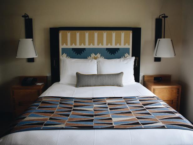 Bed With Fabric Headboard and Throw With Geometric Patterns