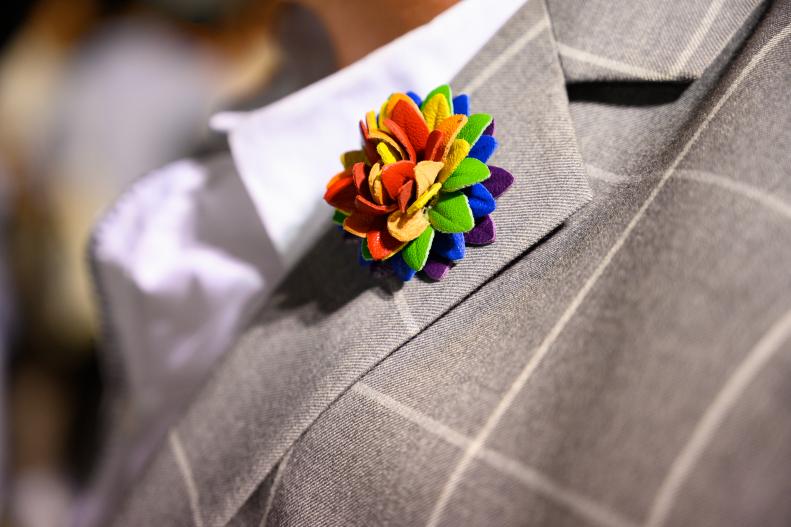 Close Up of Suit Lapel With Rainbow Flower Pin