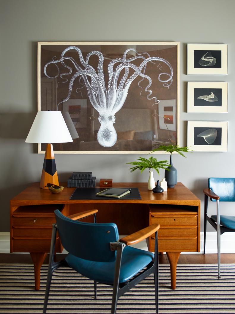A home office features a vintage desk and octopus artwork.
