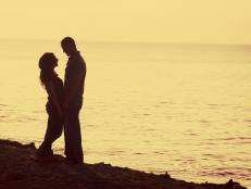 Silhouette Of A Couple Standing On The Beach