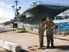 Zak and Aaron go over plans outside the USS Hornet.