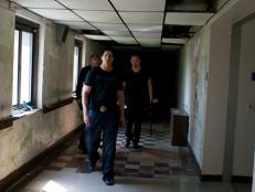 Zak, Nick and Aaron walk down one of Hill View Manor's decrepit hallways.