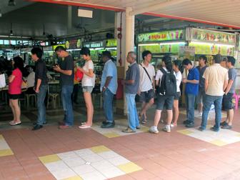 At the Hawker Center, Tony waits patiently in line for nasi lemak, an iconic rice dish.