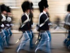 Guards march in front of the Amalienborg Palace, the winter home of the royal family of Denmark.