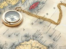 old brass compass on the vintage map