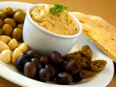  'Hummus with olives, pickled garlic and chillies'