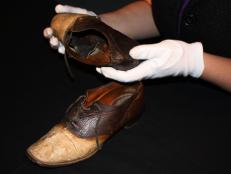 Carbon County Museum Director Tiffany Wilson holding a special pair of shoes.