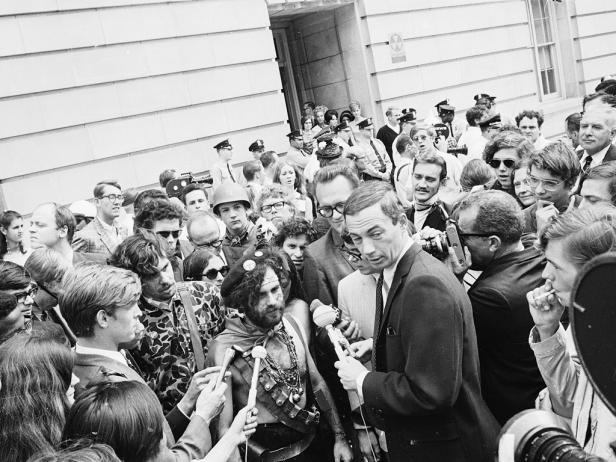  'News crews interview American activist Jerry Rubin (1938 - 1994) outside the 1968 Democratic National Convention, Chicago, Illinois, August 1968. Rubin, who founded the Yippees political party, and six others, called the Chicago Seven, were indicted for conspiracy and inciting a riot during the convention. (Photo by Hulton Archive/Getty Images)'
