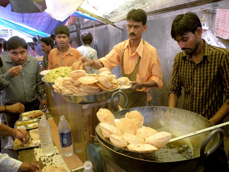 Pani puri are fried bread dough filled with spicy beans-- popular with hawker stands in Mumbai.
