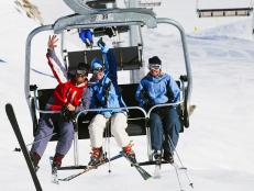 Skiers waving from ski lift