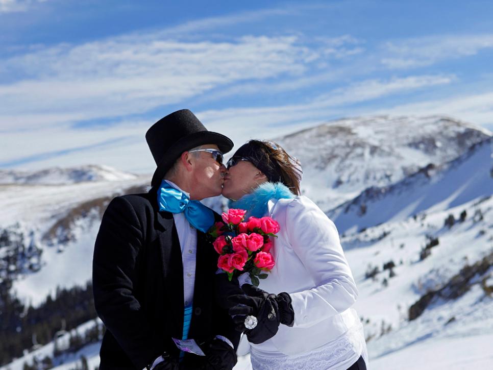 Couple kisses while skiing