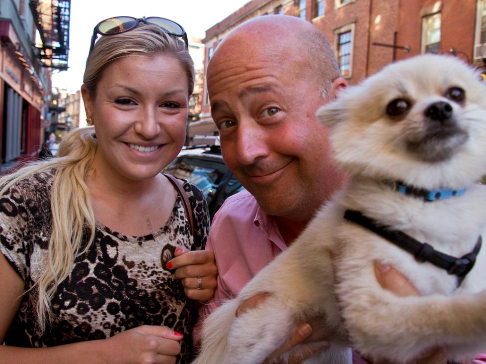 Andrew Zimmern with a fan and her dog