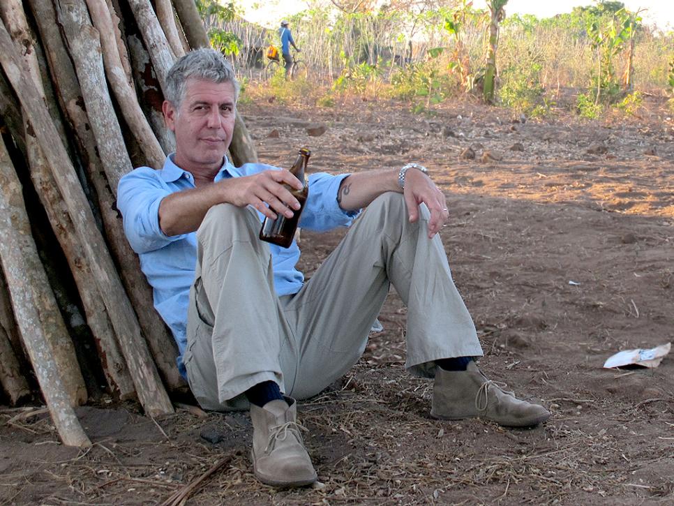 Tony Bourdain with beer in Mozambique