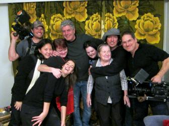 Tony Bourdain poses with a recruited family in Finland