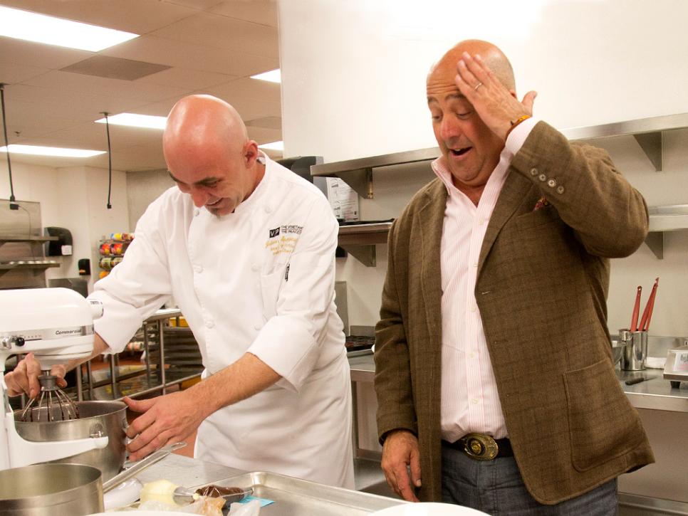 Andrew Zimmern watches a chef in Las Vegas