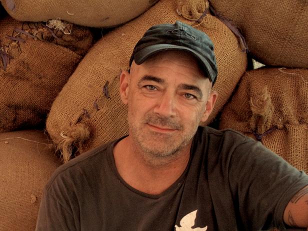 Todd Carmichael in front of coffee bags