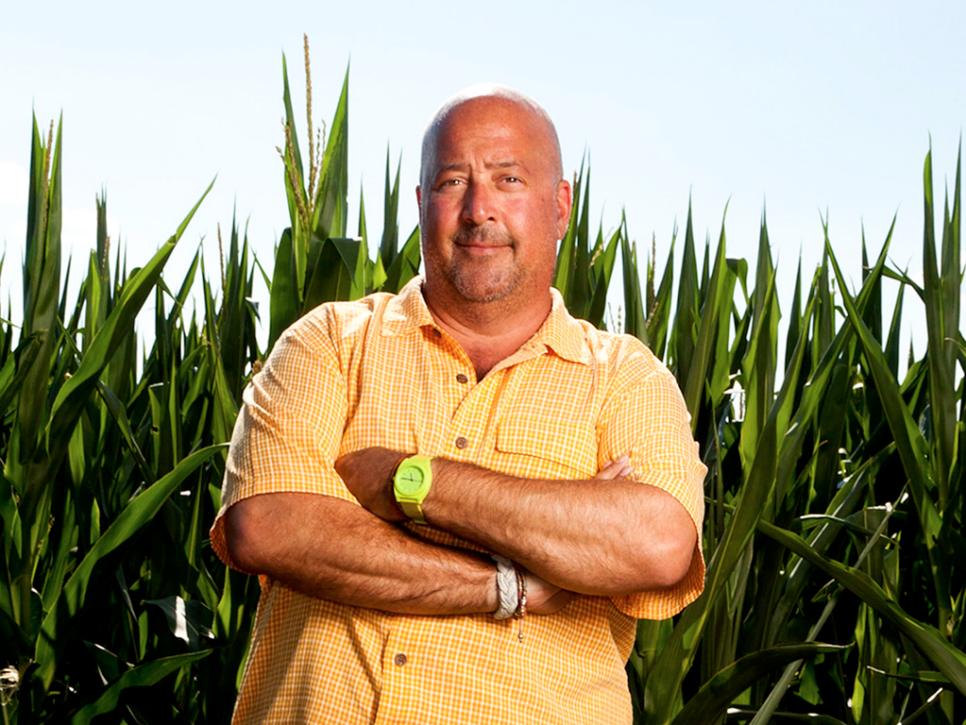 Andrew Zimmern stands in a field of corn in Iowa